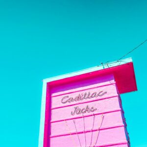 Pink roadside motel building and sign in warm light