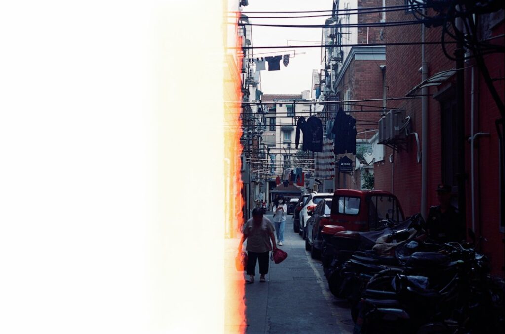Warm colorful street scene with a person walking past motorcycles
