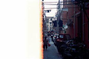 Warm colorful street scene with a person walking past motorcycles