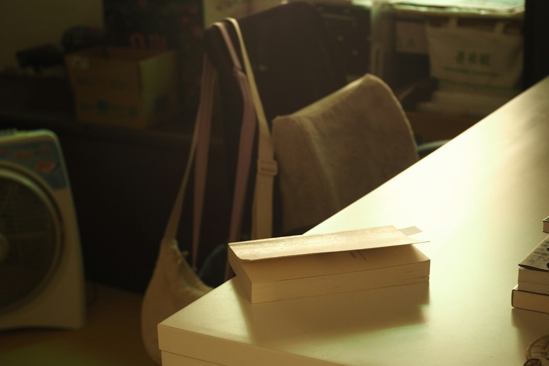 Stack of books on a publishing worktable, photographed by MChe Lee